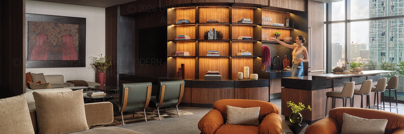Woman reaching for a wine glass in the clubroom at The Modern Austin Residences