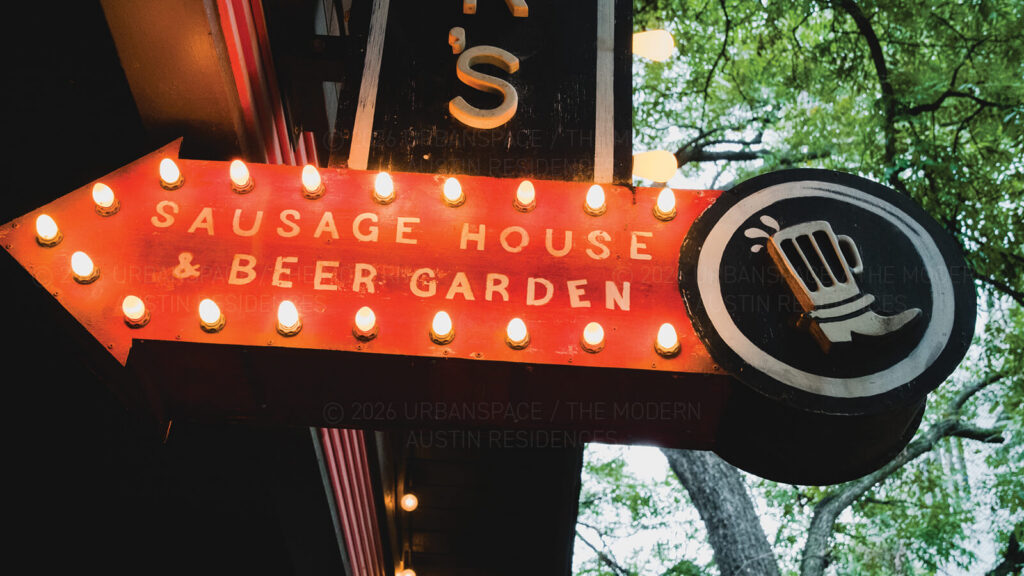 Bright red sign for Banger's Sausage House & Beer Garden with boot beer mug logo.