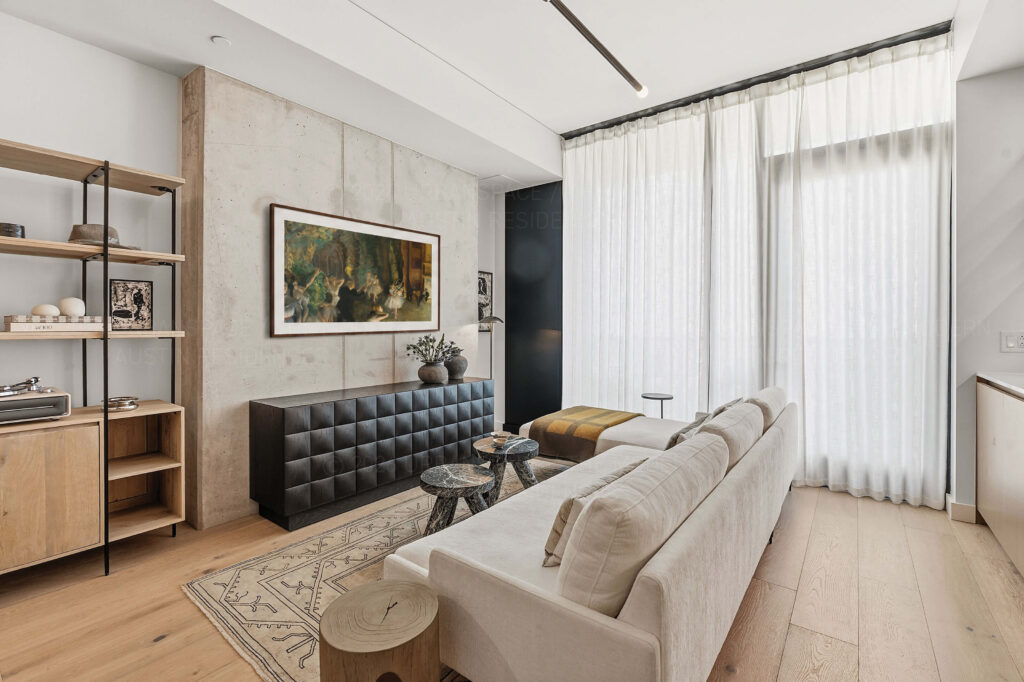 Modern condo living room with sofa and wall hung TV