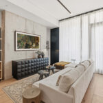 Modern condo living room with sofa and wall hung TV