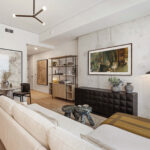 Modern condo living room with sofa and wall hung TV