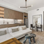 Modern condo living room with sofa and efficient kitchen