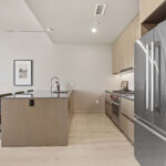 Modern condo kitchen island and refrigerator
